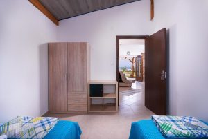 Photo showing the view of the Aegean sea from the twin beds in the two-bedroom apatment