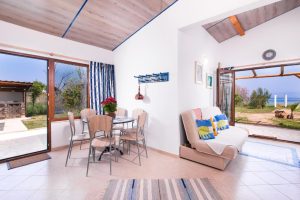 Photo of both the dining area, expandable couch and view of the sea form the two-bedroom apartment