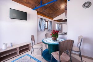 Photo of the one bedroom mall apartment with TV and dining table
