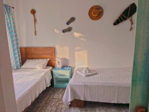 Photo of the bedroom with two separate beds in the holiday home with bedside table and wall decoration