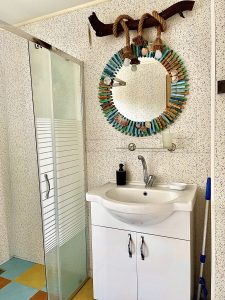 A photo of the sink, mirror and shower area in the bathroom