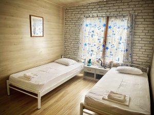 Photo of the bedroom with two separate beds and a window